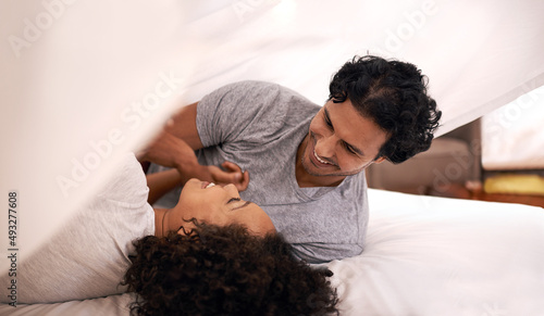 Photos Daytime is playtime. A cute couple underneath the covers.