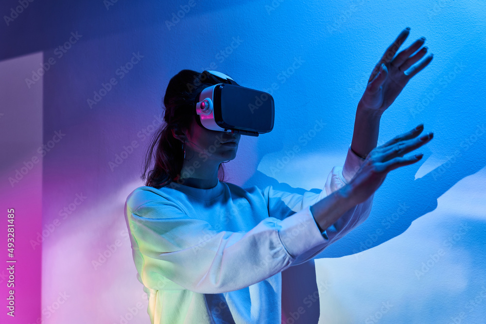Woman exploring cyberspace in VR headset Woman exploring cyberspace in VR headset