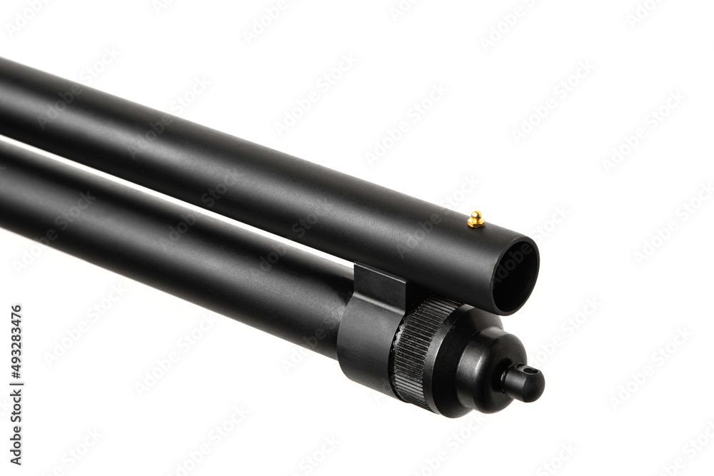 Pump-action 12 gauge shotgun isolated on a white back. Close-up shot of part of a shotgun. A smooth-bore weapon with a plastic stock. Pump-action 12 gauge shotgun isolated on a white back. Close-up shot of part of a shotgun. A smooth-bore weapon with a plastic stock.