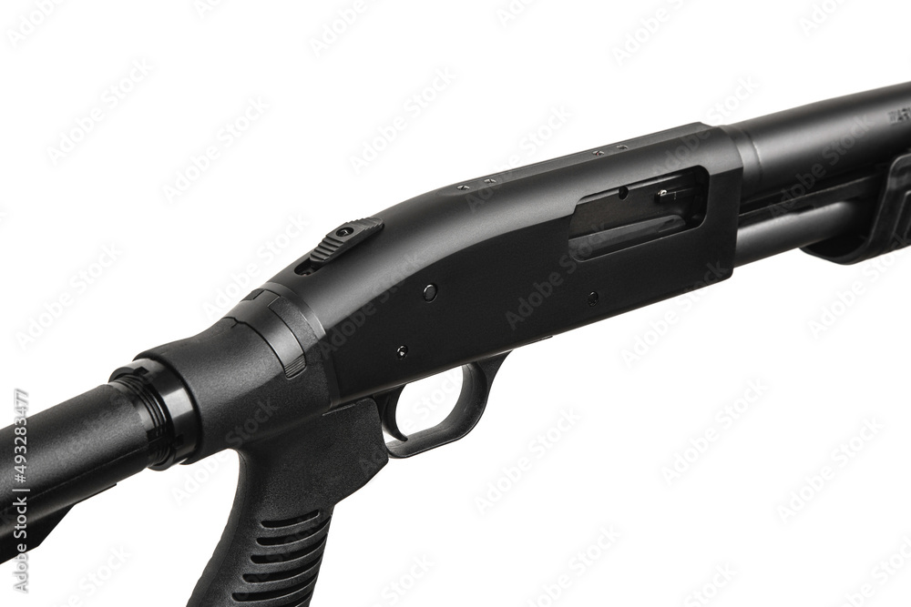 Pump-action 12 gauge shotgun isolated on a white back. Close-up shot of part of a shotgun. A smooth-bore weapon with a plastic stock. Pump-action 12 gauge shotgun isolated on a white back. Close-up shot of part of a shotgun. A smooth-bore weapon with a plastic stock.