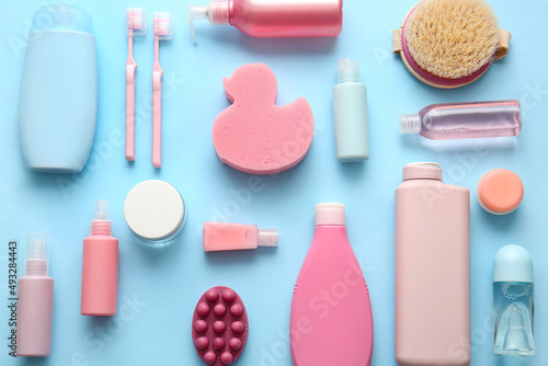 Composition with different cosmetic products, massage brush, bath sponge and toothbrushes on color background