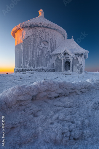 St. Lawrence Chapel on the top of Śnieżka in the Karkonosze Mountains. Winter view of the snow-covered building.