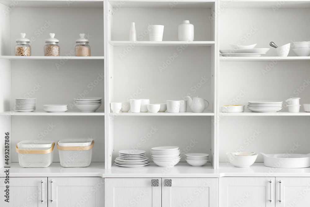 Shelf unit with set of clean dishes in kitchen Shelf unit with set of clean dishes in kitchen