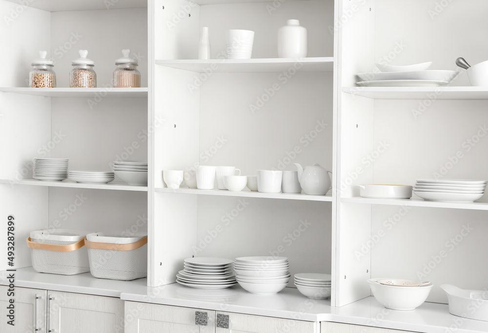 Shelf unit with set of clean dishes in kitchen Shelf unit with set of clean dishes in kitchen