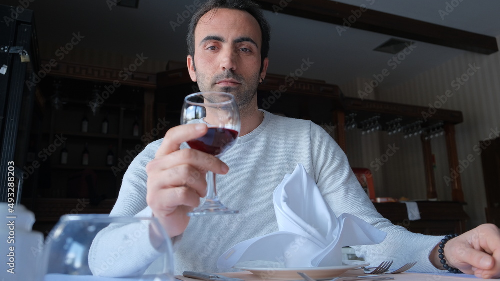 Man drinks wine in minimal luxury restaurant in hotel for summer time. Man drinks wine in minimal luxury restaurant in hotel for summer time.