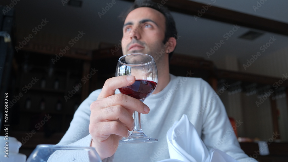 Man drinks wine in minimal luxury restaurant in hotel for summer time. Man drinks wine in minimal luxury restaurant in hotel for summer time.