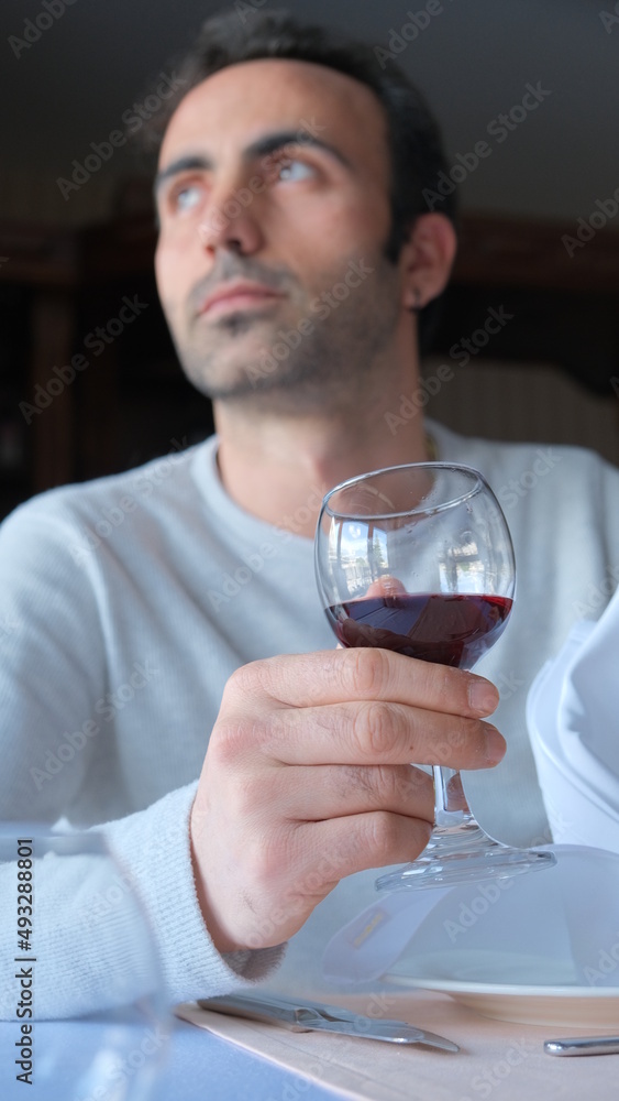 Man drinks wine in minimal luxury restaurant in hotel for summer time. Man drinks wine in minimal luxury restaurant in hotel for summer time.