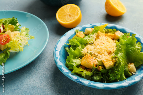 Plates with tasty vegan Caesar salad on color background, closeup