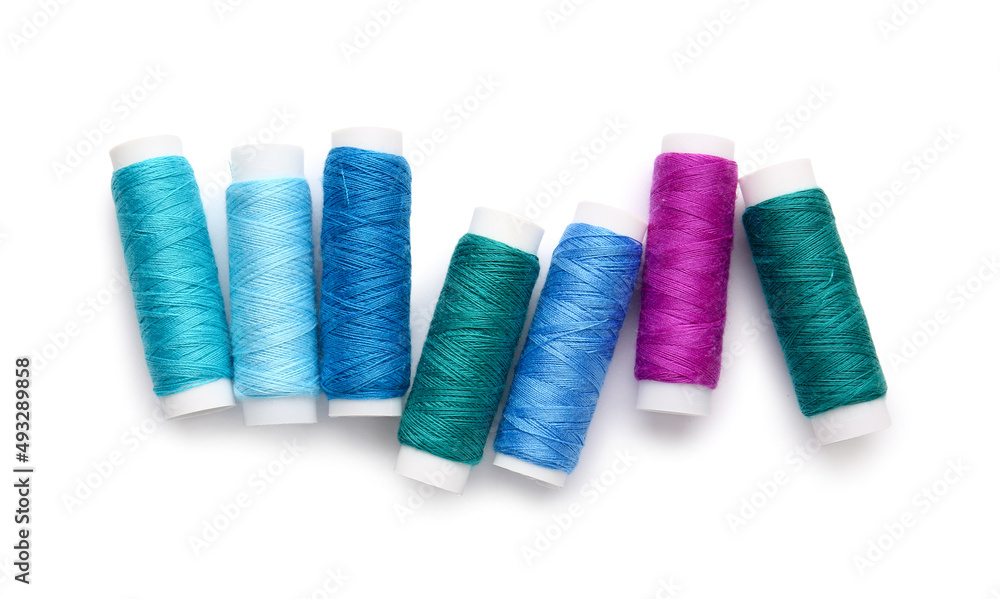 Different thread spools on white background Different thread spools on white background