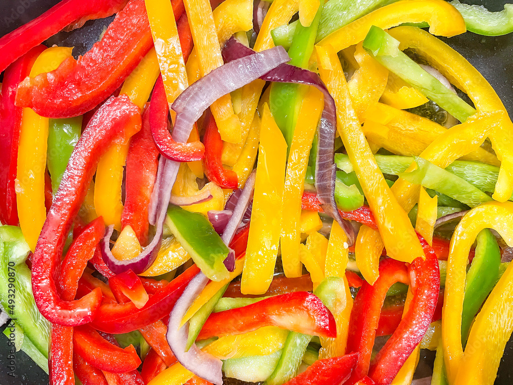 Closeup, red, green and yellow peppers, grilled, cut into strips, as healthy ingredients for cooking, concepts.
