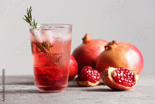 Glass of tasty pomegranate cocktail on table