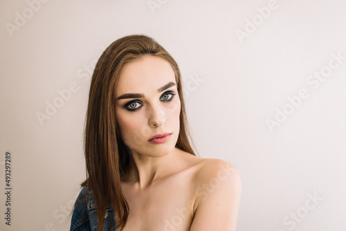 Sexy brunette woman looking at camera. Bright evening makeup, smoky eyes.