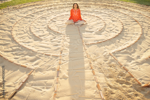 Woman sitting in the middle of a meditation labyrinth