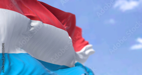 Detail of the national flag of Luxembourg waving in the wind on a clear day.