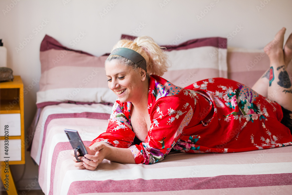 Happy woman texting with her phone while relaxing Happy woman texting with her phone while relaxing