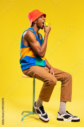 Man in retro clothes eating apple photo