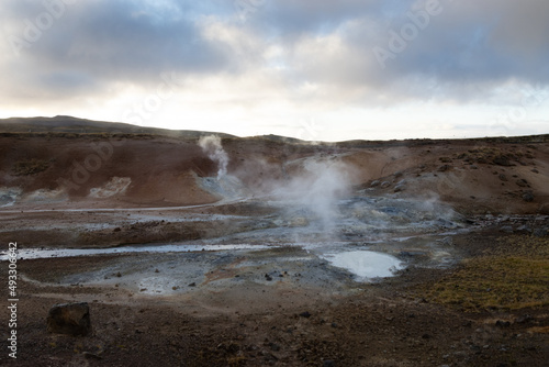 volcanic landscape with smoke in the air