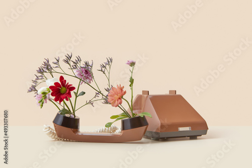 Spring flowers blooming inside retro style telephone