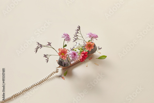 Retro telephone handset with spring flowers photo