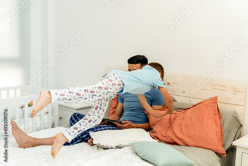 child straight up in the air falling towards the bed