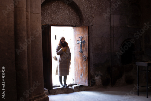 woman standing open church door
