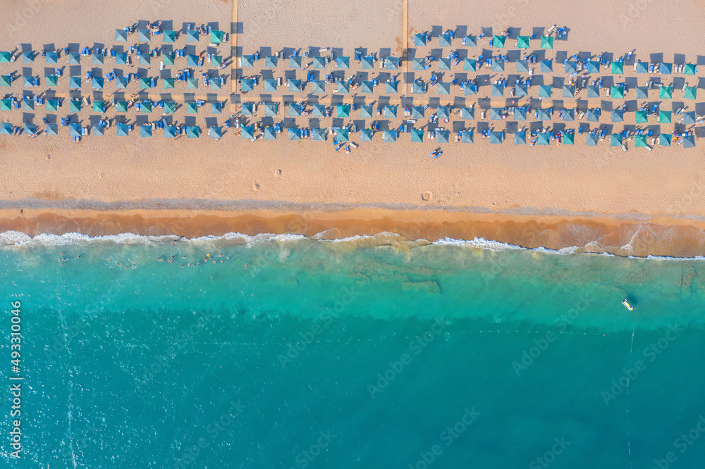 Beach with umbrellas on the Mediterranean Sea. Wtd from a drone. Aerial photography