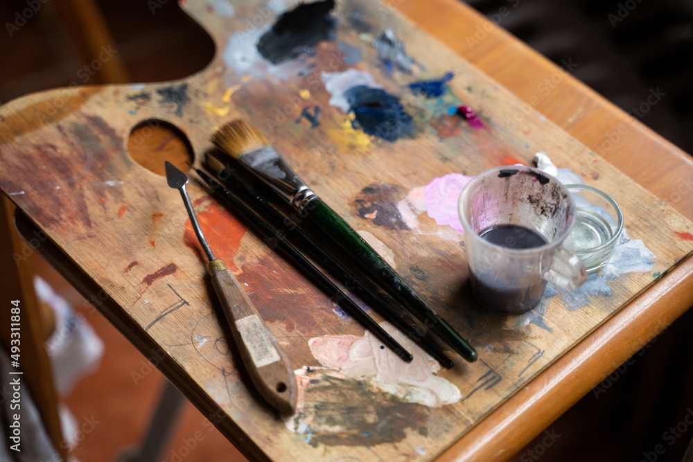 Detail of paint and brushes at art studio Detail of paint and brushes at art studio