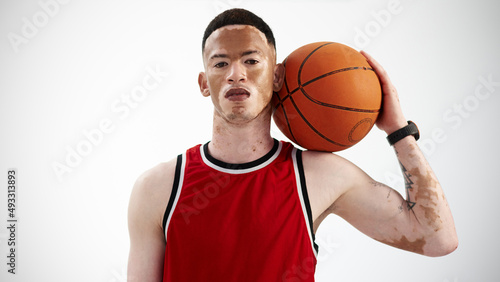 Im ready to ball. Cropped portrait of a handsome young male basketball player posing in studio.