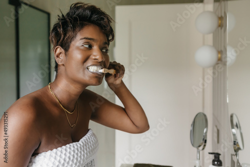 Woman cleaning her teeth in a modern bathroom photo