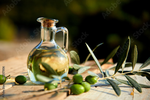 Fototapeta Naklejka Na Ścianę i Meble -  olive oil and green olive on the wooden background