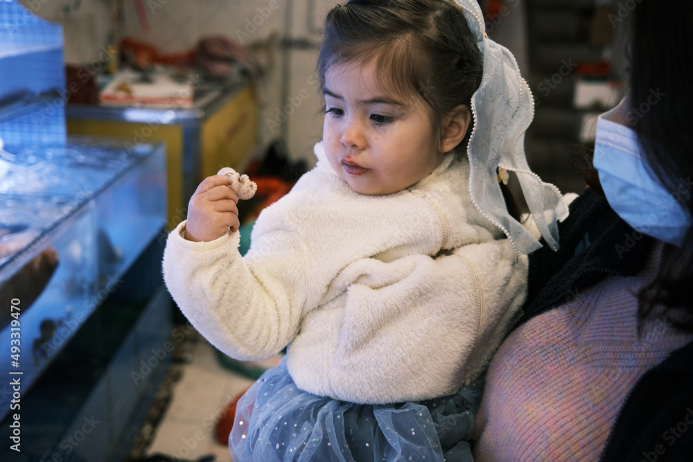 Young Mixed Race Asian Toddler Holding A Little Octopus Young Mixed Race Asian Toddler Holding A Little Octopus