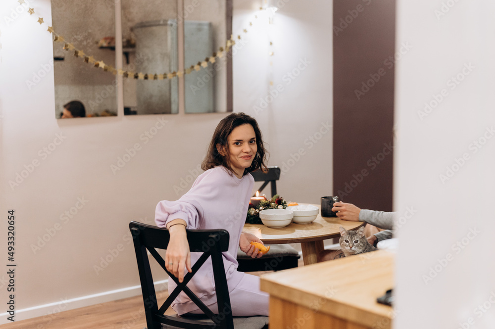 Smiling woman at table in kitchen Smiling woman at table in kitchen