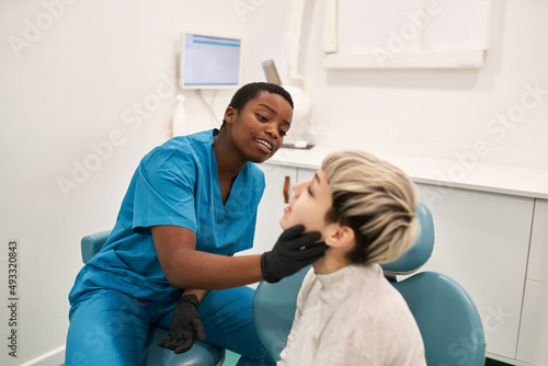 Young patient complaining to dentist photo