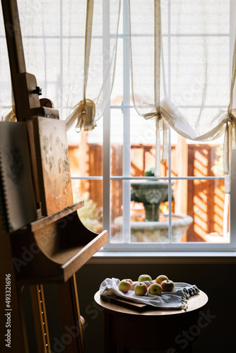 Artist easel with a painting of still life apples