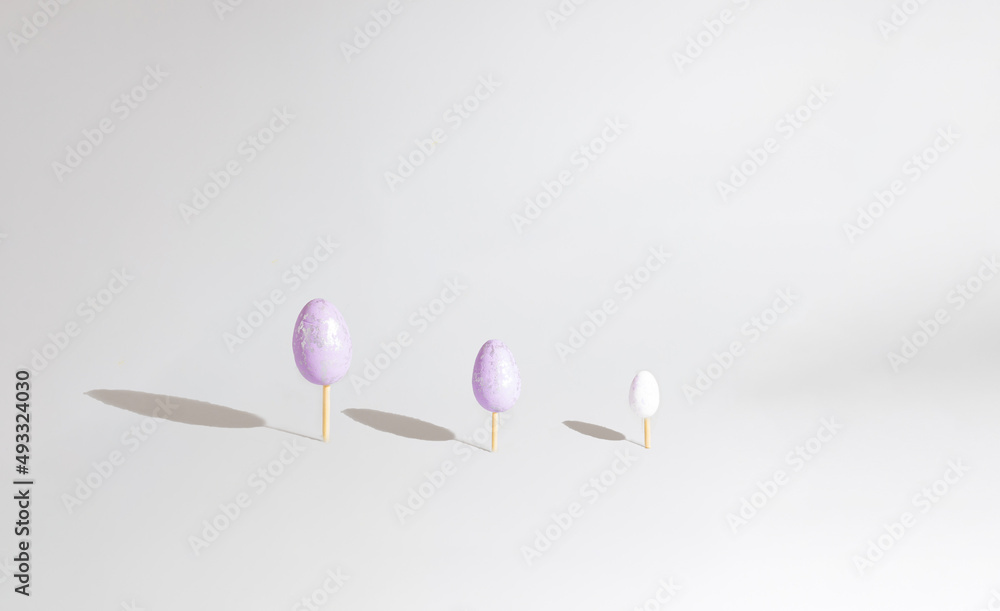 Fototapeta premium Three Easter eggs like three tree creative design pastel color and background. Easter minimal concept.
