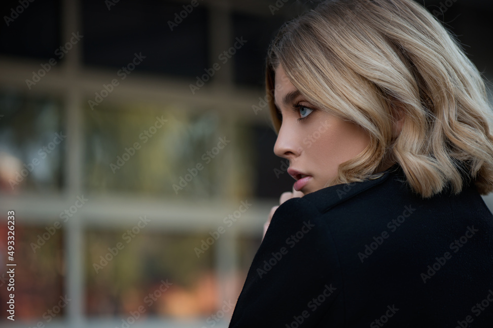 Beautiful young woman in a coat in the city. Beautiful young woman in a coat in the city.