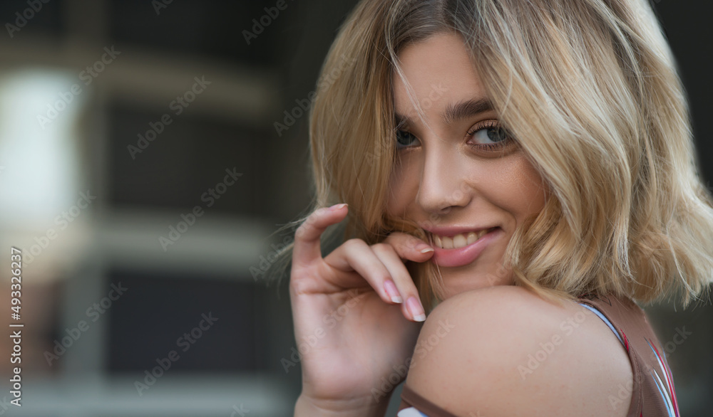 Young beautiful woman smiles at the camera. Young beautiful woman smiles at the camera.