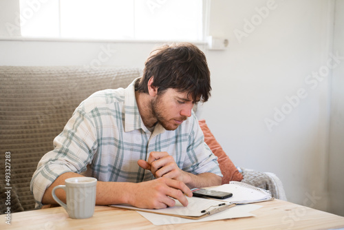 Focused man doing paperwork and bill payments photo