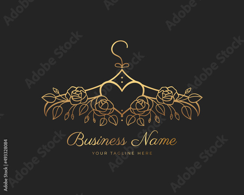 Hanger logo design with golden roses and a heart in the middle. Element for Atelier, wedding boutique, women's clothing store and fashion designer