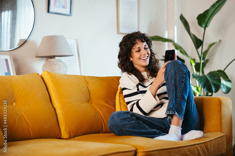 Brunette reading jokes on smartphone Brunette reading jokes on smartphone