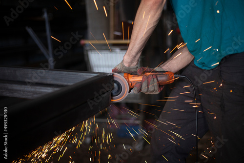Fotografie, Tablou Work with a grinder for metal.