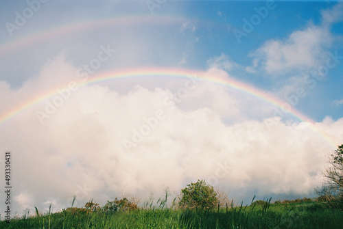 rainbow in blue sky  