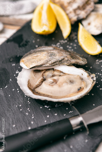 Opening Oysters on Slate Cutting Board photo