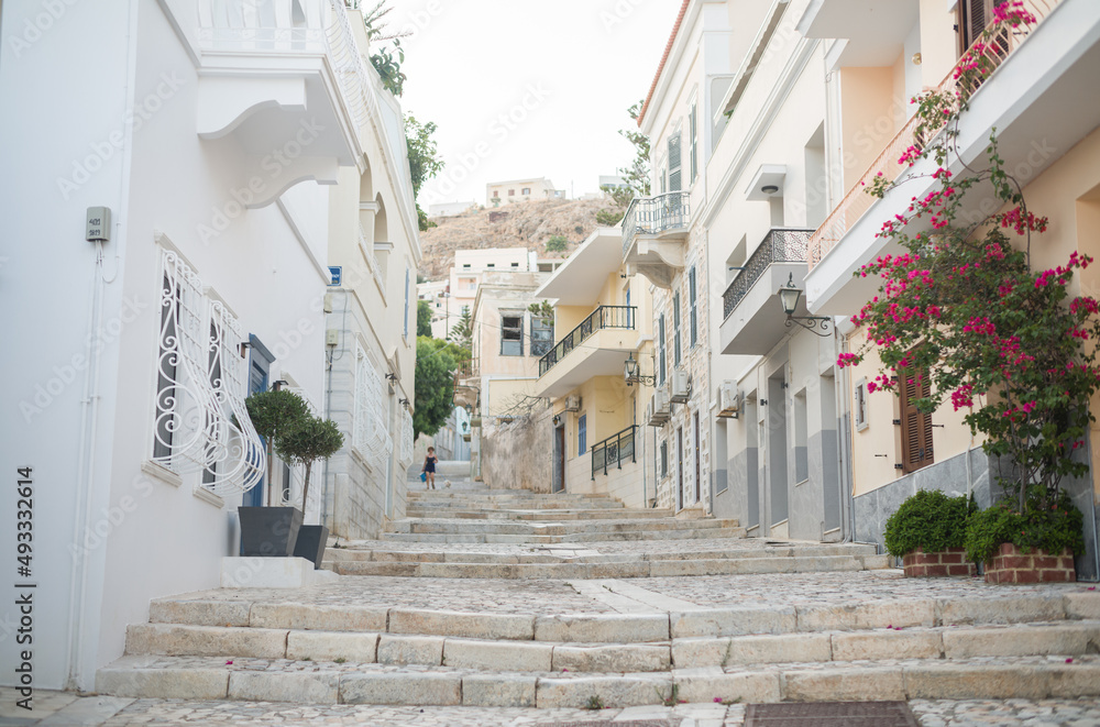 Sightings of Syros Island in Greece Ermoupolis town with neoclassical mansions of exquisite taste and intensely colourful bougainvillaea glorious sunshine framed by the dazzling Aegean Sea