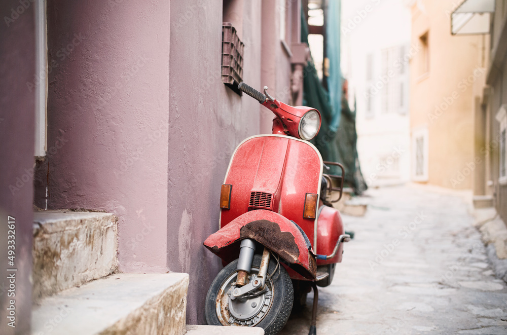 Old scooter vespa model in gorgeous Ermoupolis most attractive cities in Cyclades, capital of Syros neoclassical mansions of exquisite taste and elegance, beautiful churches, and romantic alleys