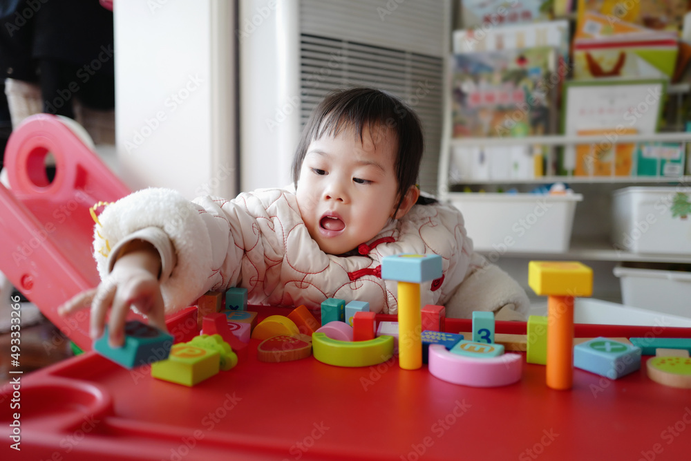 Asian baby builds blocks alone Asian baby builds blocks alone