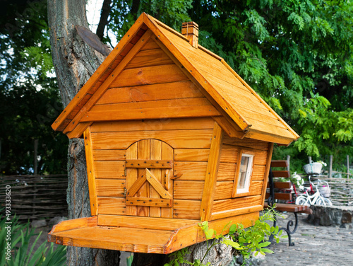 Wooden birdhouse. Wooden hut for birds or small animals. © syberianmoon