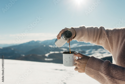 hiker drink tea in mountains photo