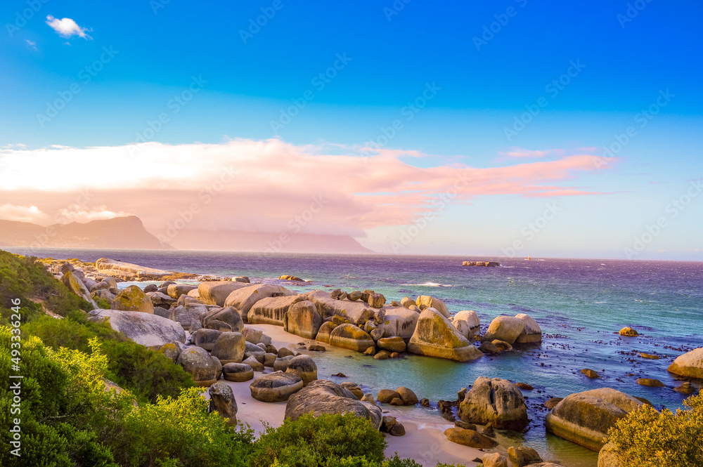 Boulders is a turqoise rocky and sheltered beach in cape town taken as sunset