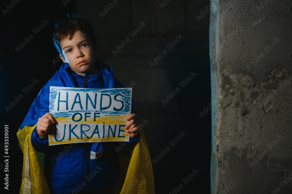 Ukrainian Crying boy holds a painted flag of Ukraine. War of Russia ...